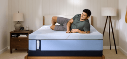 Man laying on a Posturepedic Plus Hybrid mattress