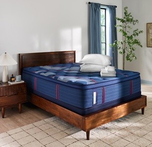 A Sealy Sleep Bundle laying on top of a Posturepedic Elite Spring mattress