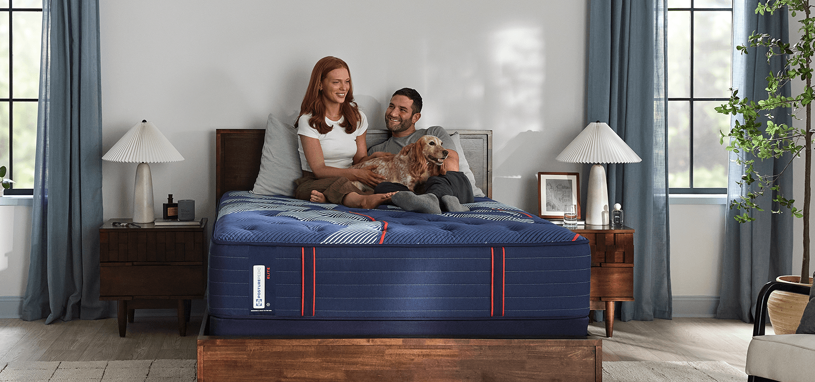 Couple laying on a Posturepedic Elite Spring mattress
