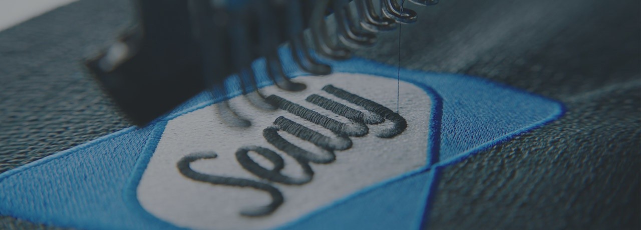 Sealy Logo Being Embroidered On Mattress